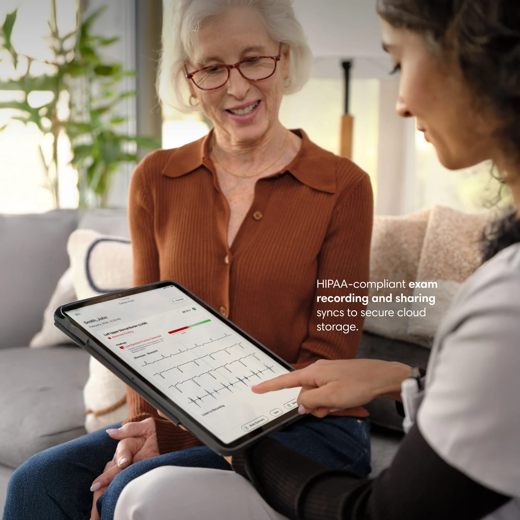 Clinician reviewing a recorded Eko exam on a tablet with a patient Clinician reviewing a recorded Eko exam on a tablet with a patient